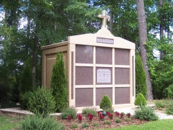 Nine-space mausoleum with large cross and granite inlays in the columns in Hoover, AL