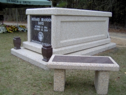 Single basic mausoleum with vases on a foundation/slab with a bench in Dunn, NC