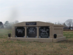 Three-space wide mausoleum with fluted columns, vases on pedestals in Trinity, AL