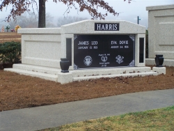 Side-by-side deluxe mausoleum with granite inlays in the columns, vases on pedestals and step-up trim pieces