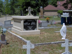 Single basic mausoleum with a cross in Vancleave, MS