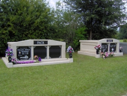 Three-space wide mausoleum with fluted columns, vases on pedestals, step-up trim pieces and a side-by-side deluxe mausoleum in Escatawpa, MS