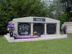 Three-space wide mausoleum with fluted columns, vases on pedestals, step-up trim pieces in Escatawpa, MS