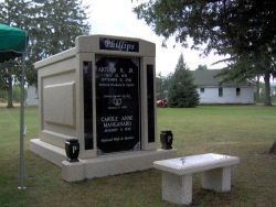 Over-and-under (stack) deluxe mausoleum with granite in the columns, two vases on pedestals, a bench in Berwick, PA