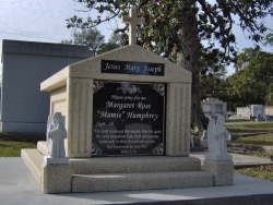 Custom single deluxe mausoleum with fluted columns and a cross with 2 angels on pedestals and step-up trim pieces on a foundation/slab in Biloxi, MS