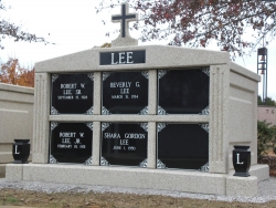 Six-space wide mausoleum with cross, fluted columns, vases on pedestals in Trussville, AL