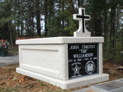 Single basic mausoleum with cross in Luverne, AL