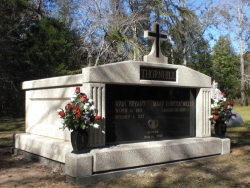 Side-by-side deluxe mausoleum with fluted columns and a cross, vases on pedestals, on a foundation/slab in Thomasville, AL