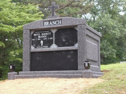 Four-space deluxe mausoleum deep gray with cross, fluted columns, vases on pedestals, step-up trim pieces in Glassgow, VA