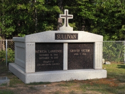 Side-by-side deluxe mausoleum with fluted columns and a cross in Linden, AL