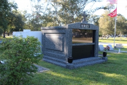 Three-space wide mausoleum deep gray with fluted columns, vases on pedestals, step-up trim pieces in Slidell, LA