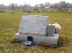 Single granite slant headstone with a vase and all on a base in Biloxi, MS