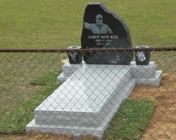 Single jet black granite headstone with 2 vases, a ledger on a concrete slab in Lucedale, MS