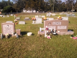 A single morning rose granite headstone and a double morning rose granite headstone in Saucier, MS