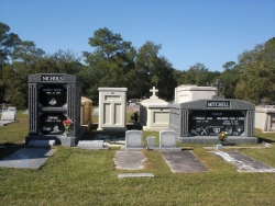 Deluxe over-and-under deep gray mausoleum with fluted columns, and a deluxe side-by-side deep gray mausoleum with fluted columns in Pascagoula, MS