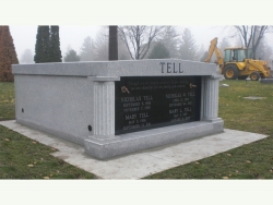 Side-by-side gray granite mausoleum with columns on a slab in Plainfield, IL