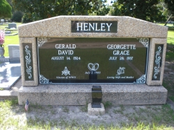 Side-by-side deluxe white mausoleum with engraved granite inlays in the columns and one vase in Pascagoula, MS