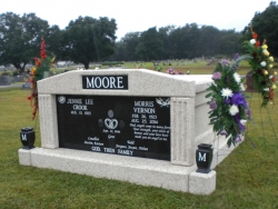 Side-by-side deluxe mausoleum with fluted columns and vases on pedestals in Oak Grove, LA